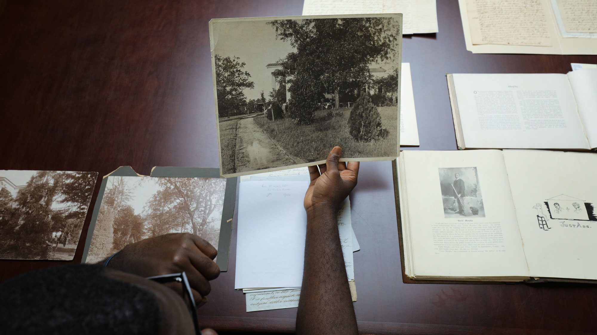 Student analyzing photograph in special collections