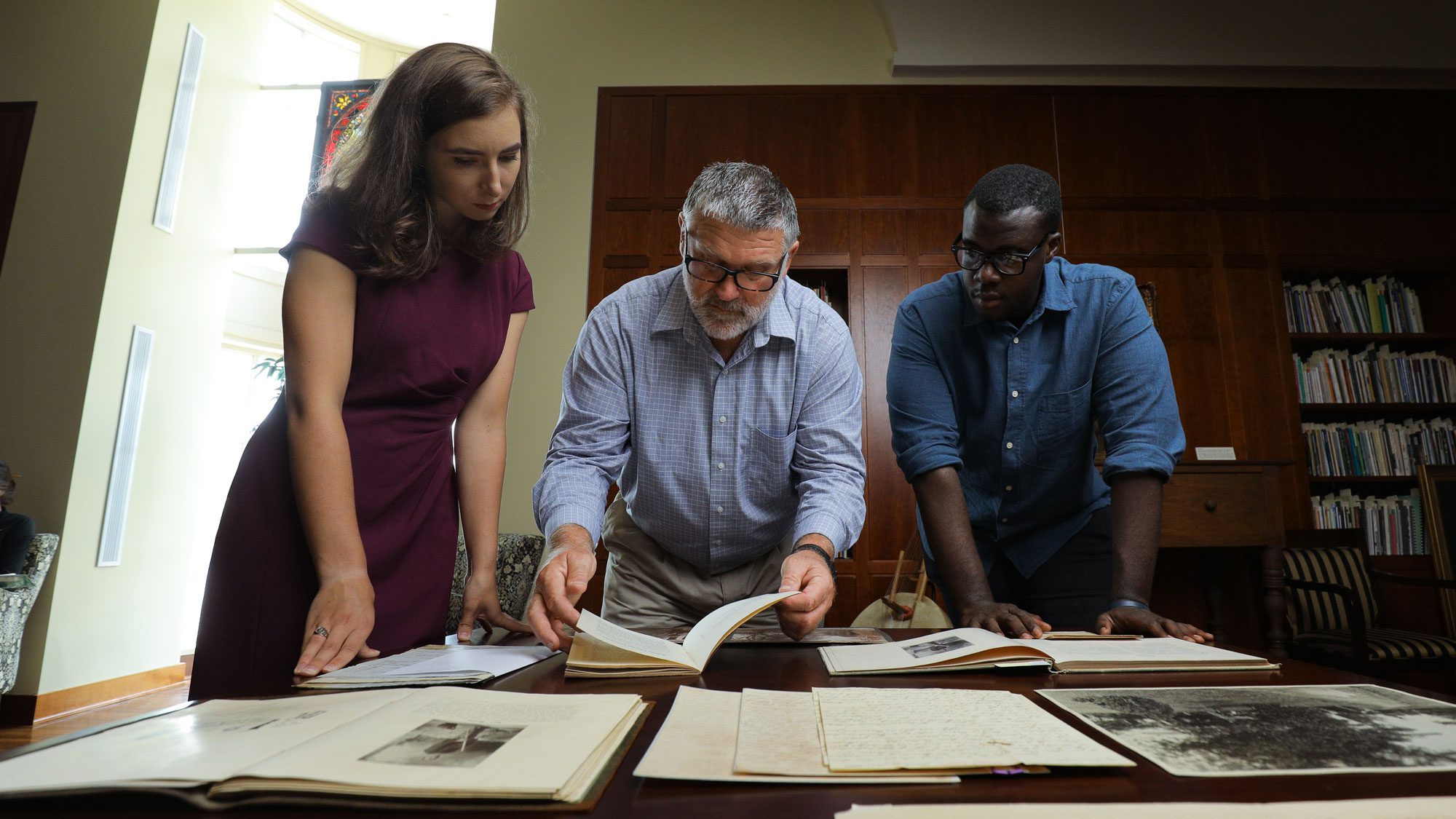 Students working with professor in special collections