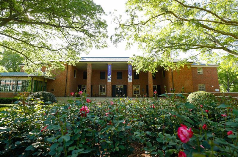 A building on Furman's campus, with roses in the foreground
