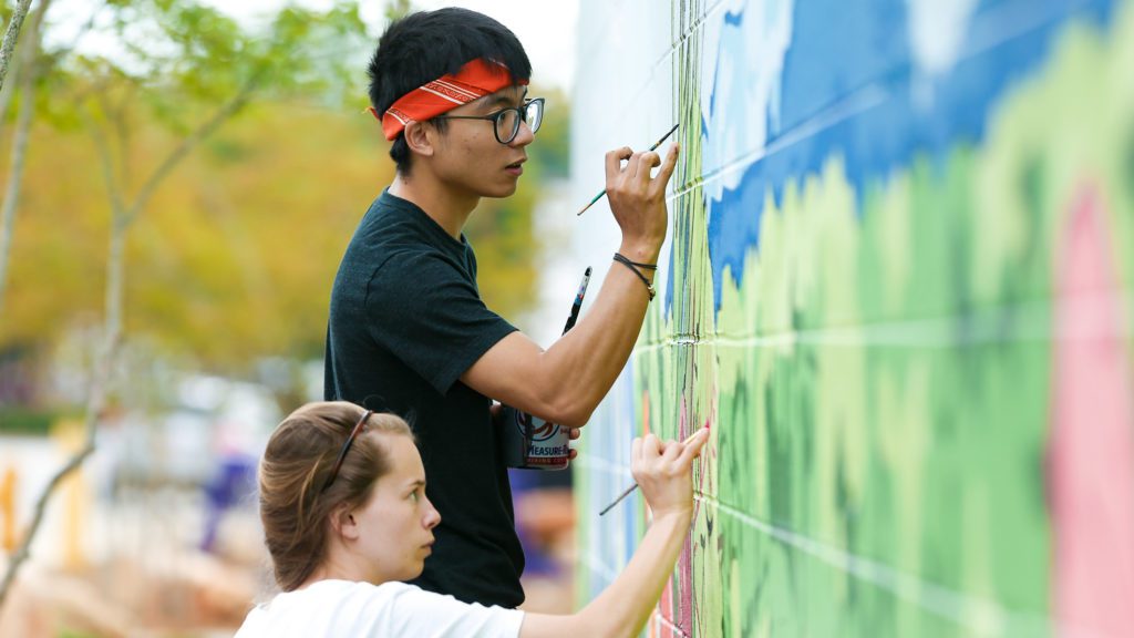 Students painting mural on STAX