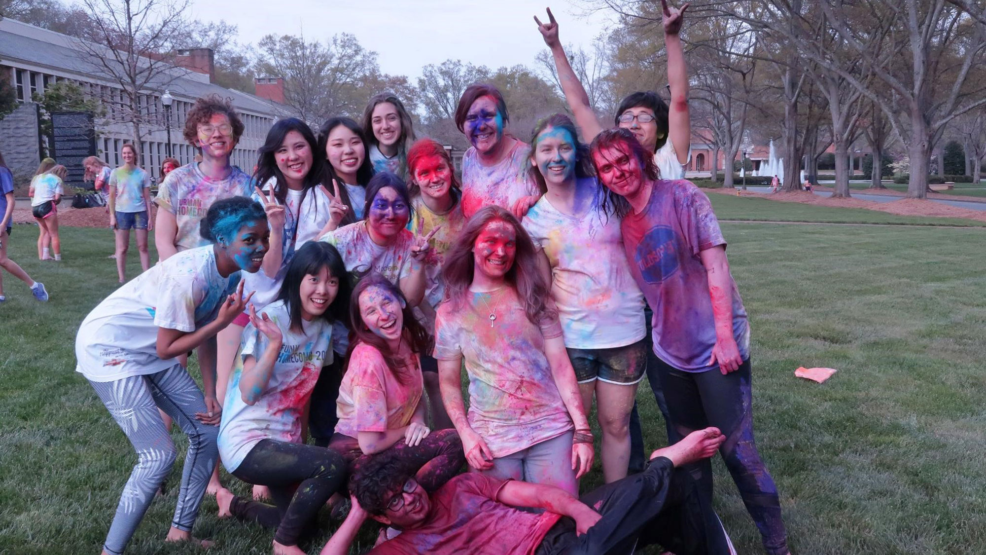 Students covered in paint after participating in holi