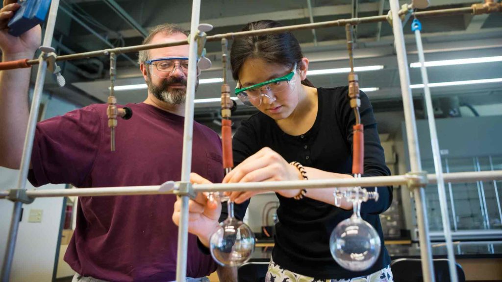 Student working with a professor in the lab
