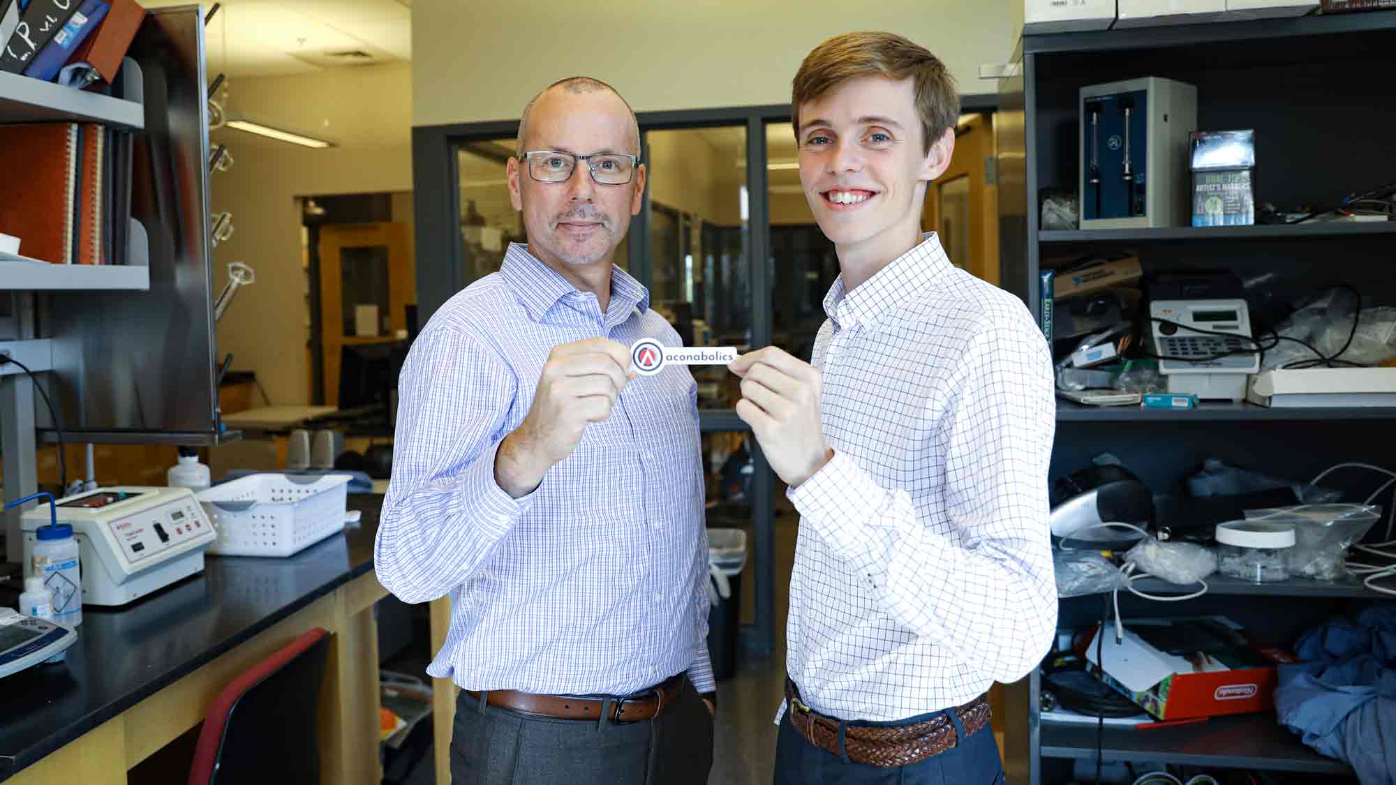 Student holding up a brand name tag
