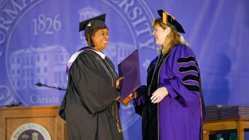 Evening studies student shaking hands with President Davis