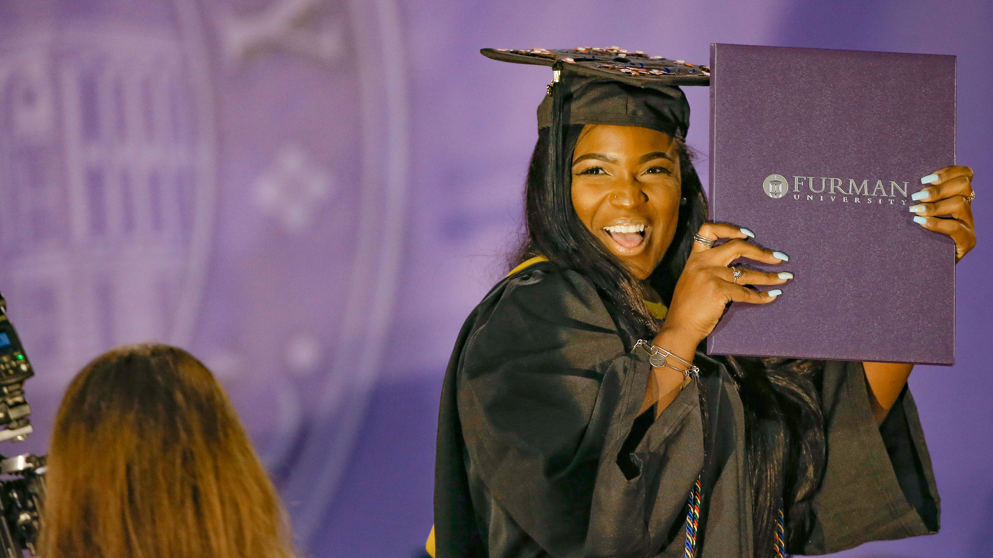 Student holding up her diploma