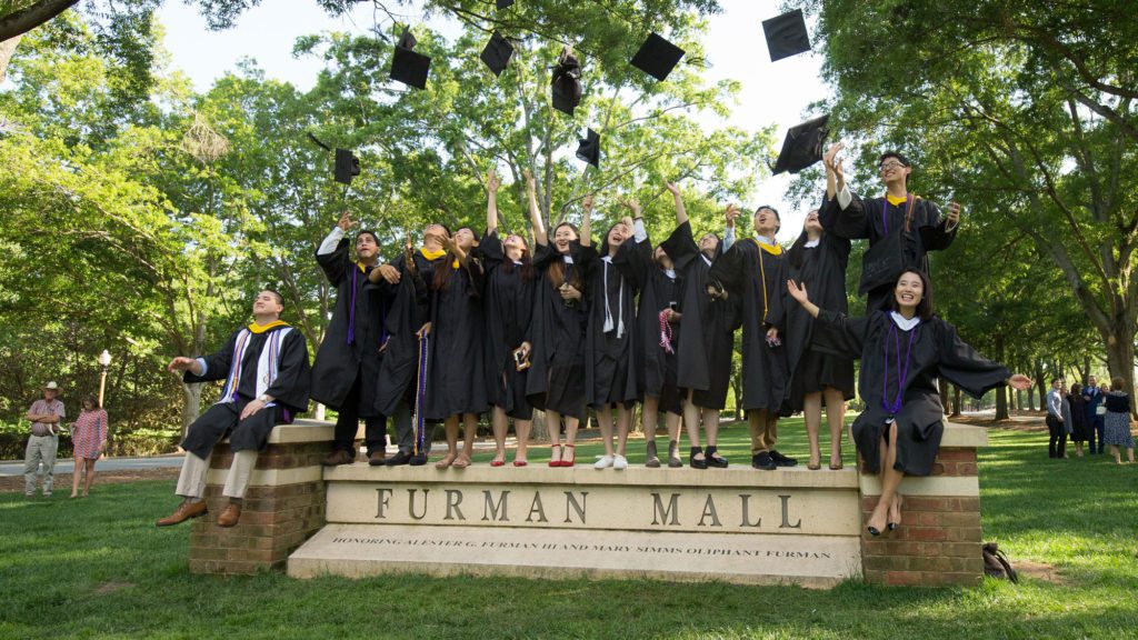 Students at commencement throwing up their caps