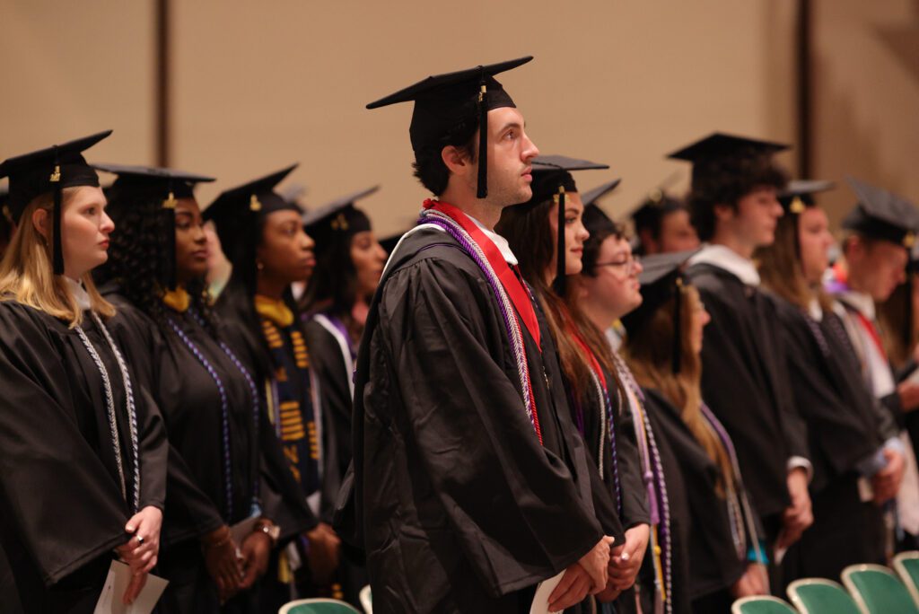 Graduates standing at the Baccalaureate celebration