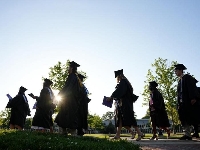 Furman graduates silhouettes walking