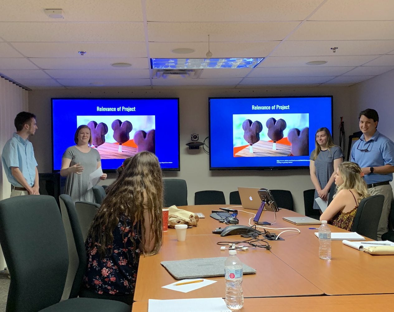 Students present Mickey ice cream bar project in conference room