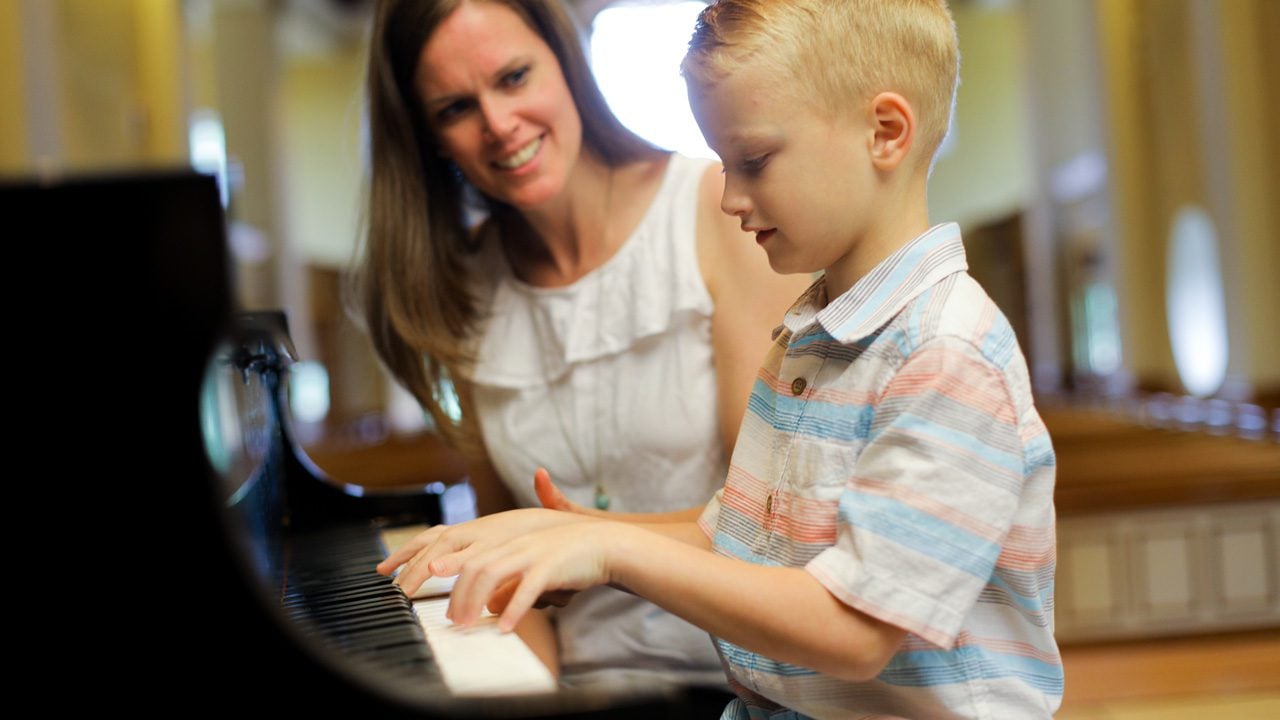 Young child playing the piano