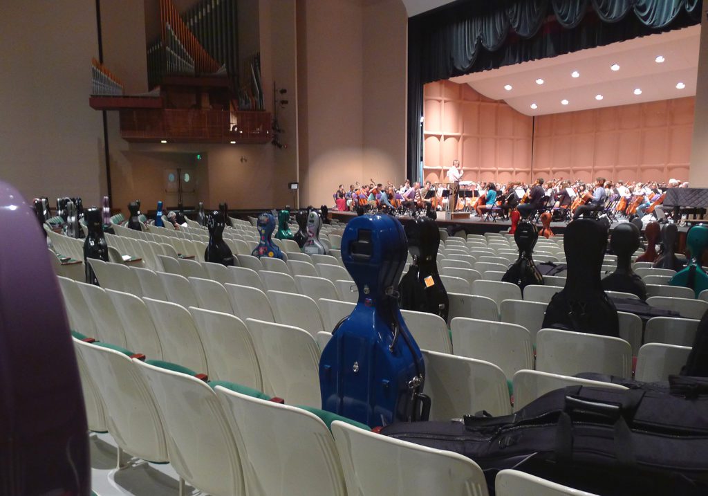 image of cello cases and cellists in mcalister auditorium