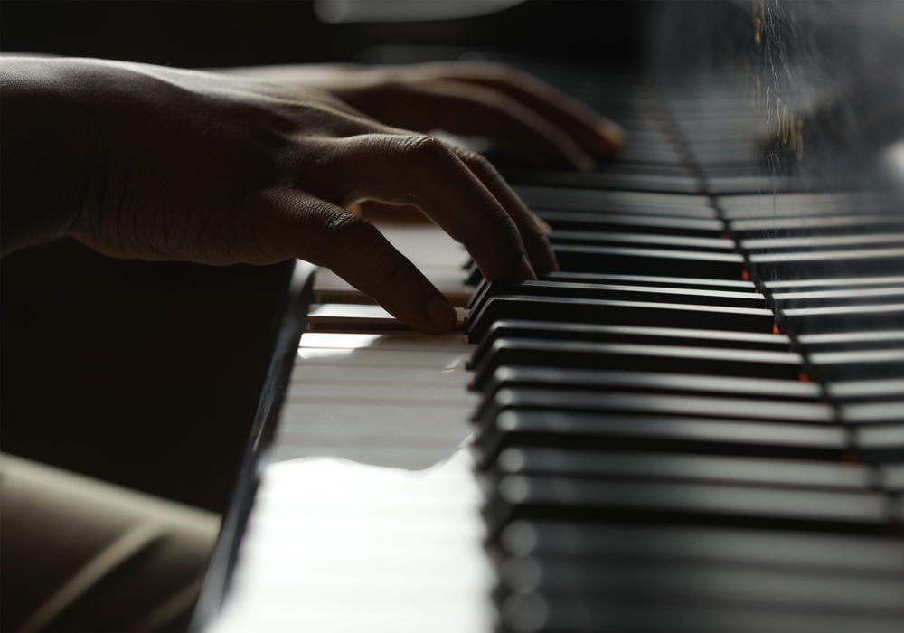 image of hands on chapel piano