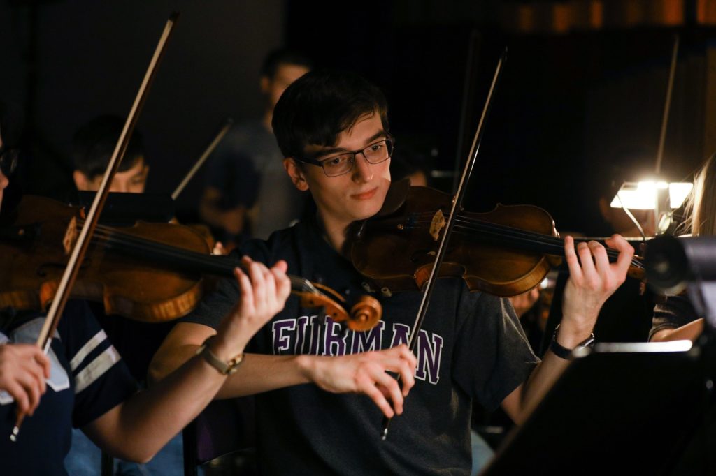 pit orchestra students playing violin