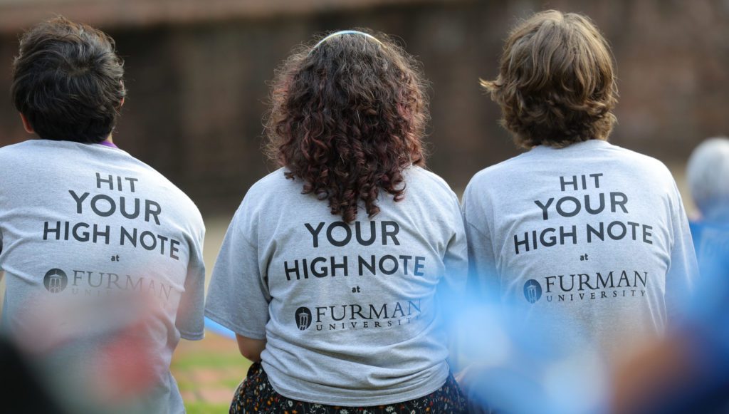 Students wearing shirts that read Hit your high note at Furman University