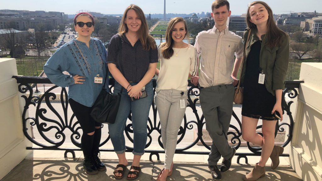 Students standing in front of view of Washington D.C.