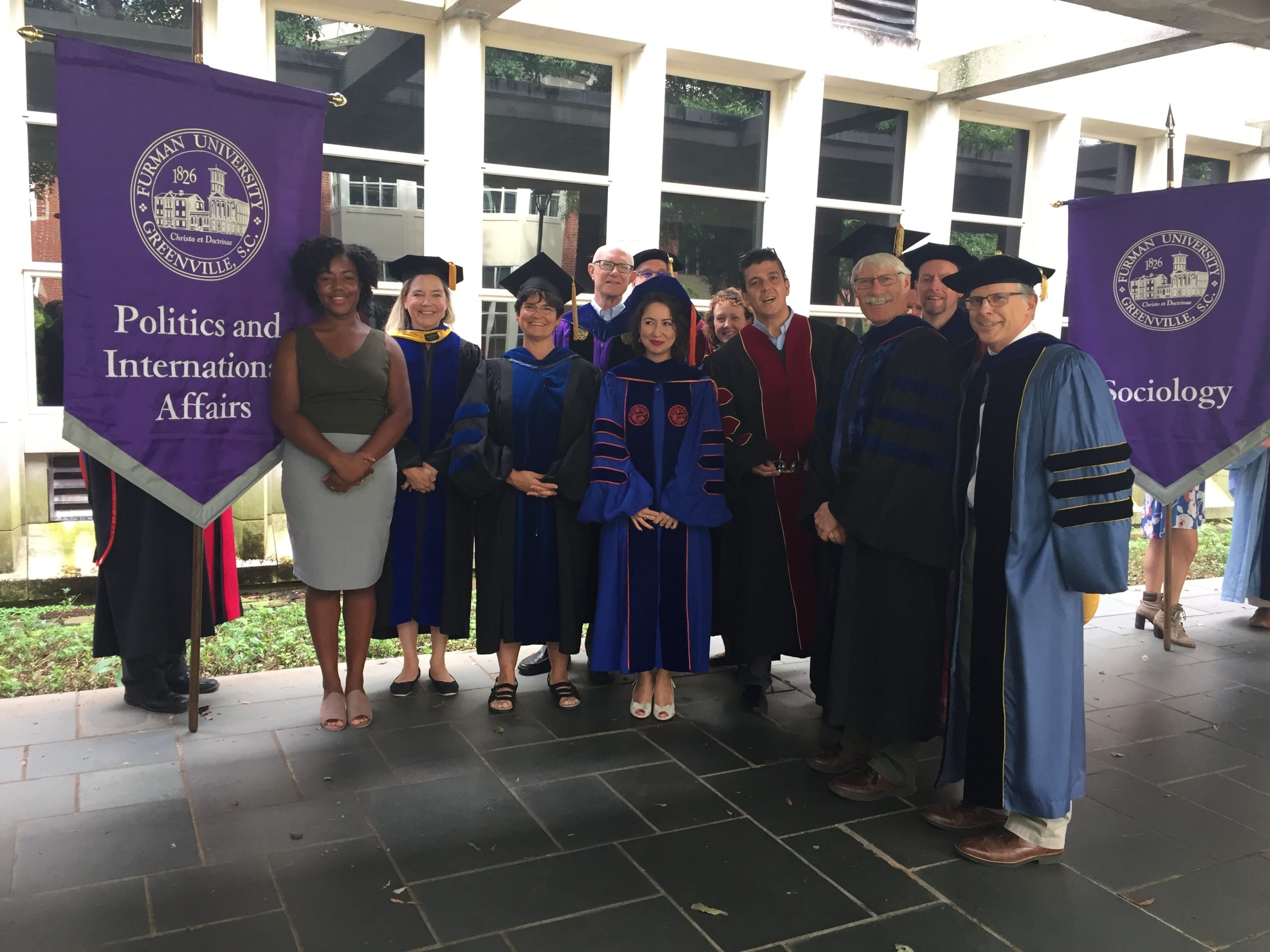 Faculty members in group with commencement garb