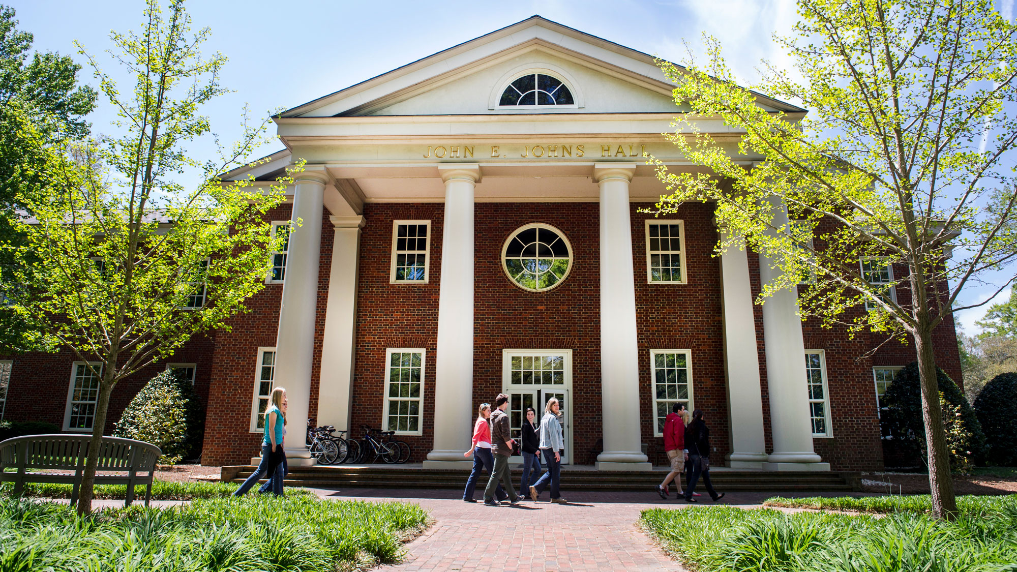 Johns Hall with students walking in front of the building
