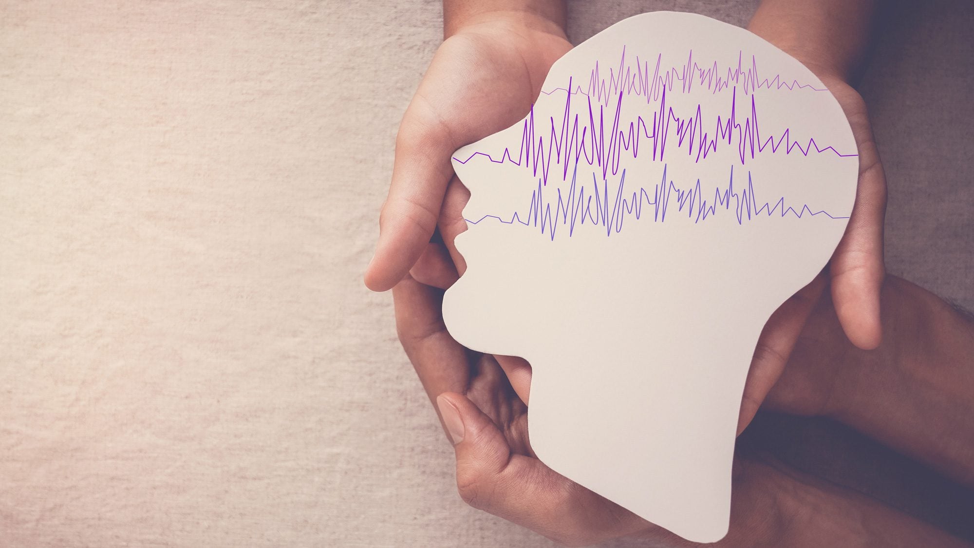 brain waves in cutout of human head