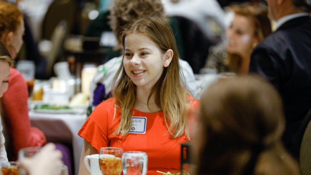 Student smiling during student awards dinner