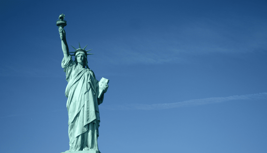 The Statue of Liberty standing tall against a clear sky, symbolizing American ideals of freedom, democracy, and global leadership.
