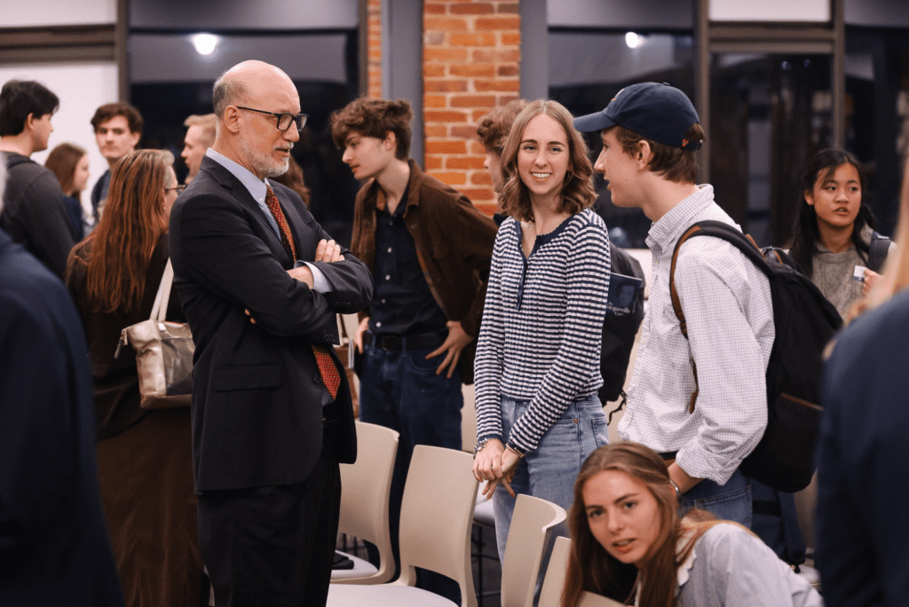Retired U.S. Foreign Service Officer Larry Richter talking with students following a Tocqueville Center lecture at Furman University.