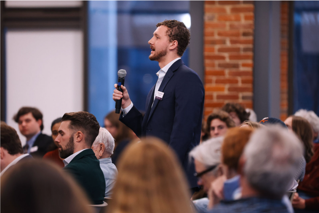 Nathan Johnson asks a question during the Q&A session, continuing a conversation about moral responsibility, technological change, and the role of religious institutions in public life.