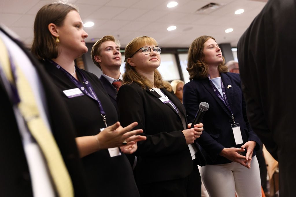 Four Tocqueville Fellows with a microphone at a Tocqueville Center event,