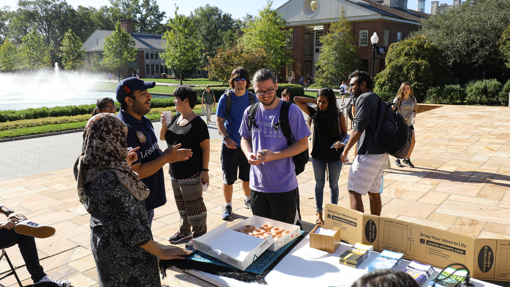 Students at a muslim meet and great in front of library