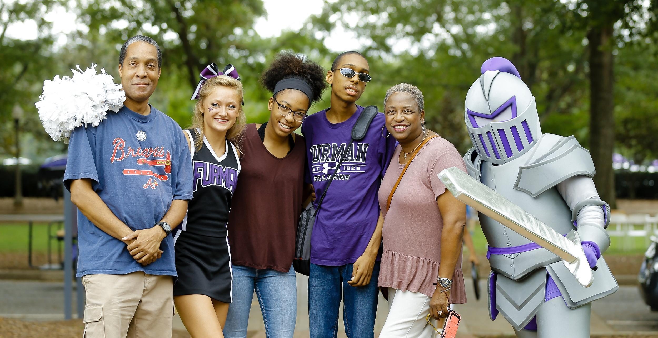 Furman parents and students standing with mascot