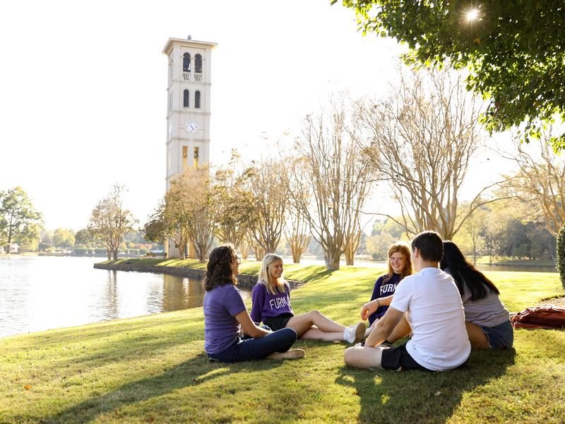 Students studying by Furman Lake together