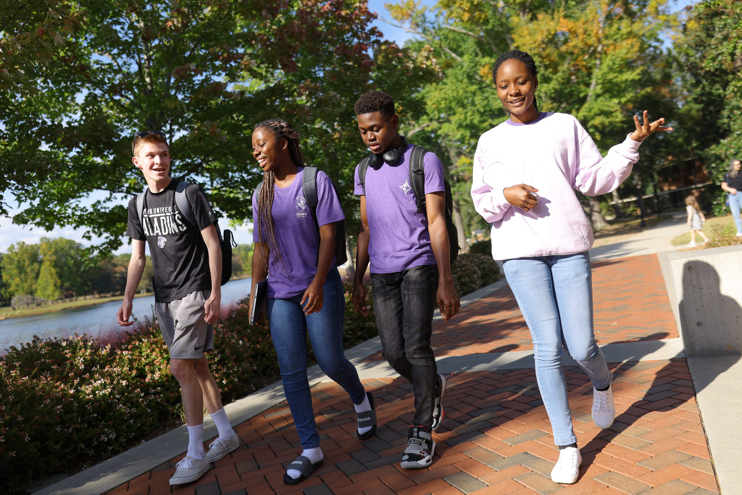 male and female students walking and talking on campus