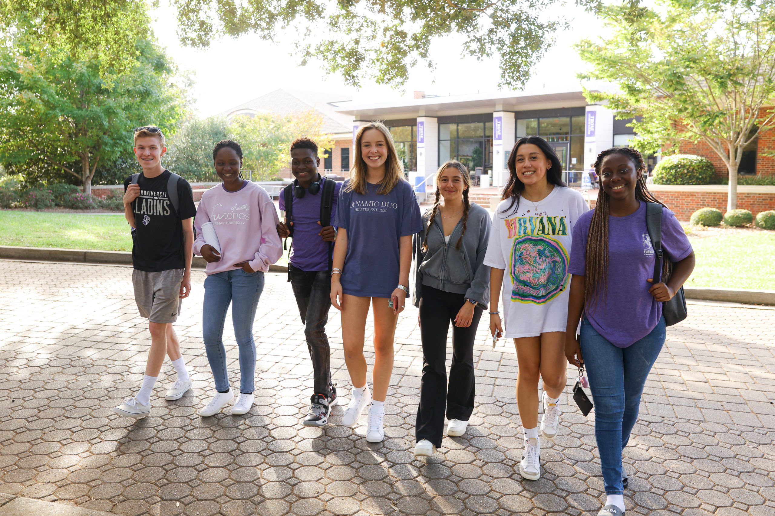 male and female students walk together on campus