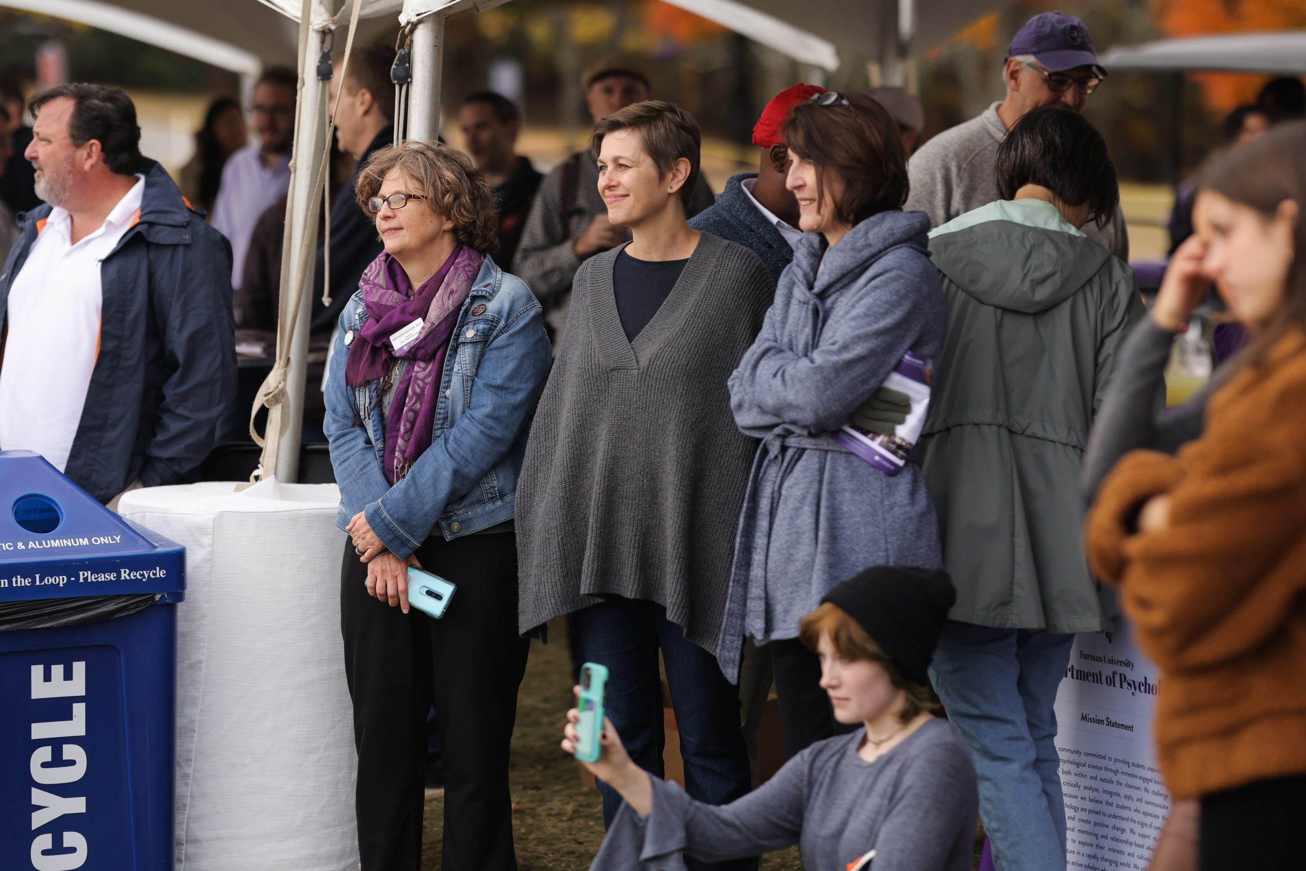 Parents standing together at an outdoor Furman homecoming event