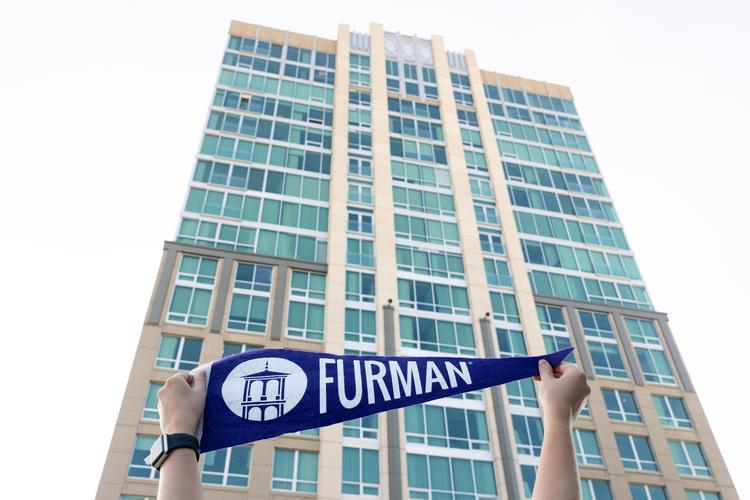 Furman pennant in front of hotel