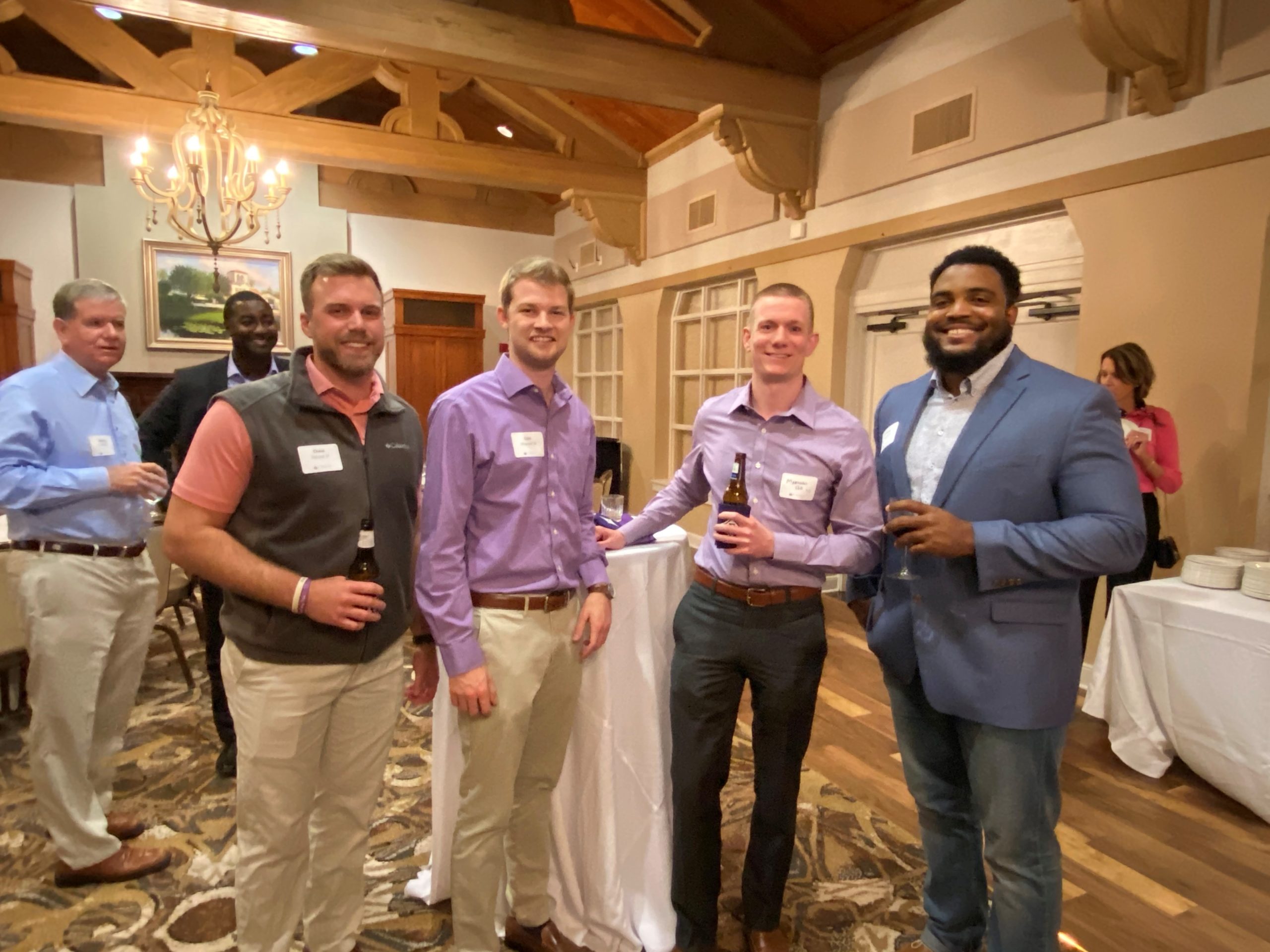 Alumni holding drinks at networking event