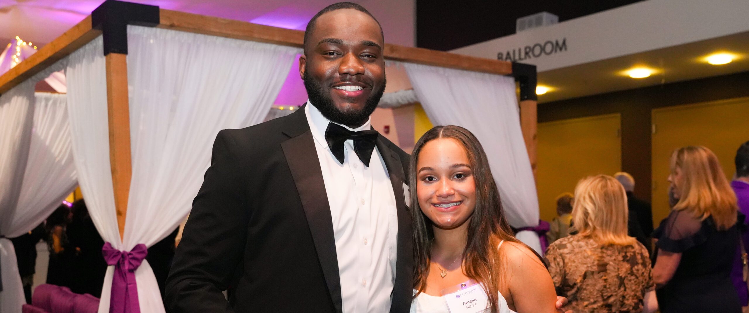 Bell Tower Ball attendees pose for a photo while enjoying drinks before the main program