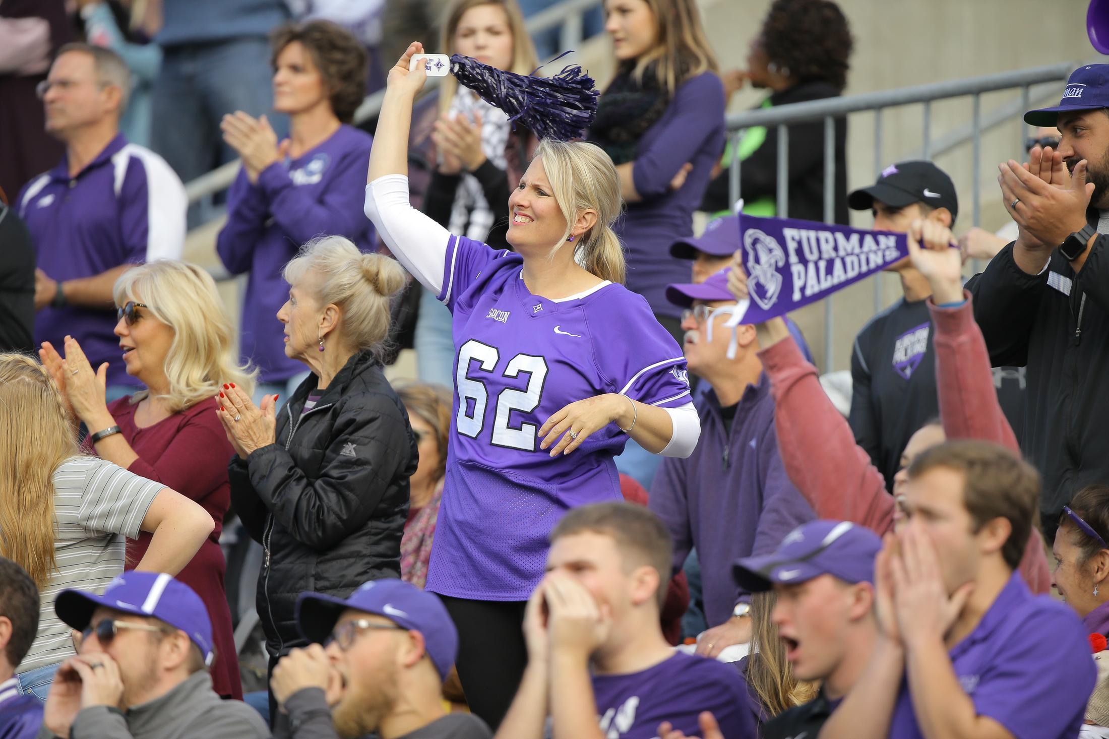 students and adults cheering during a football game