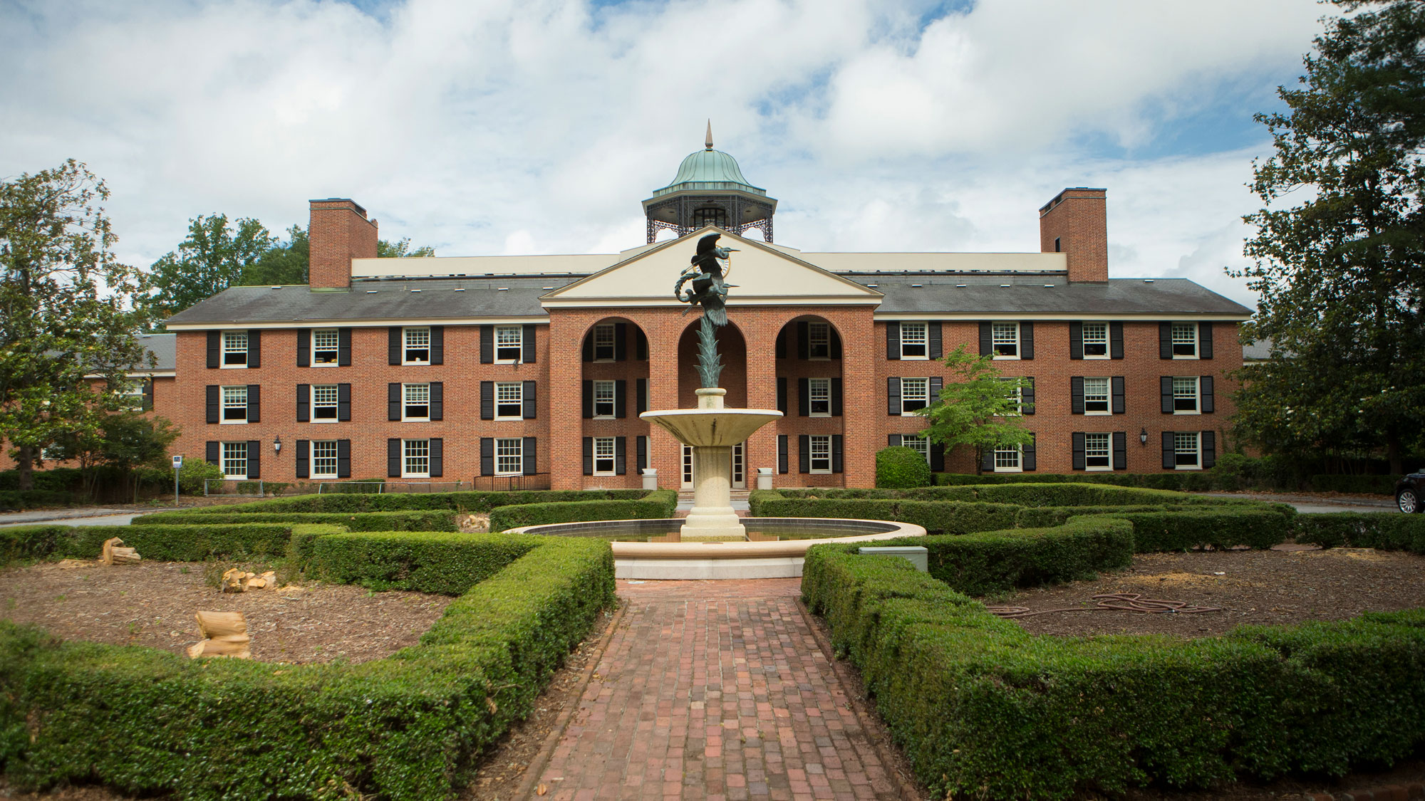 View of Lakeside building from the front, hedges and fountain as landscaping