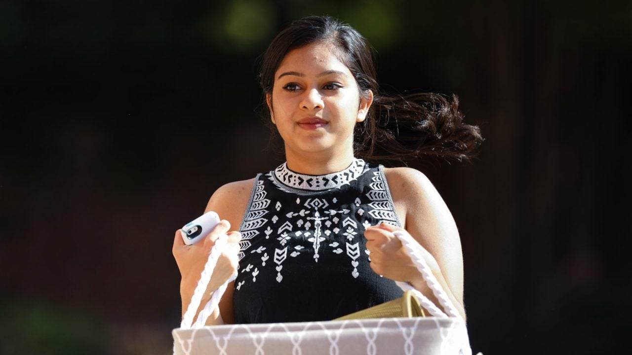 Girl carrying her items for move in