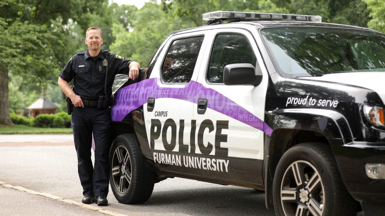 Police Officer standing outside his vehicle