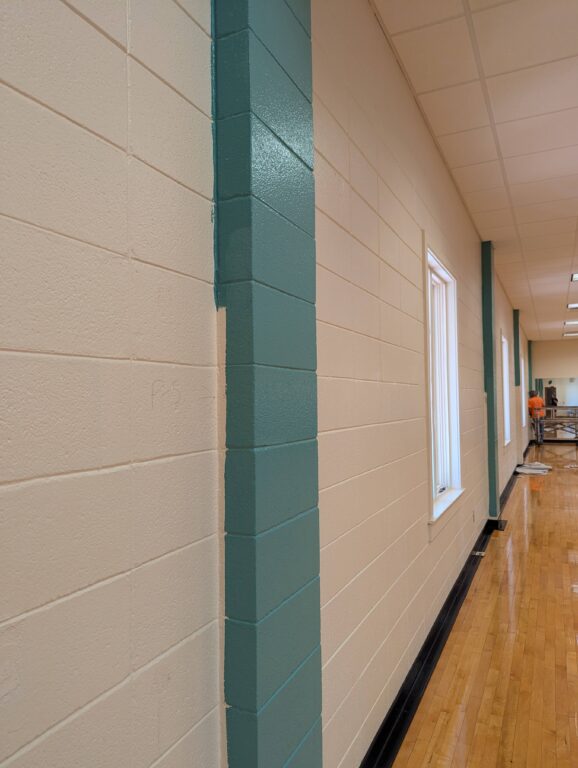Fresh blue/green paint hugs the columns in the group fitness sutdio.