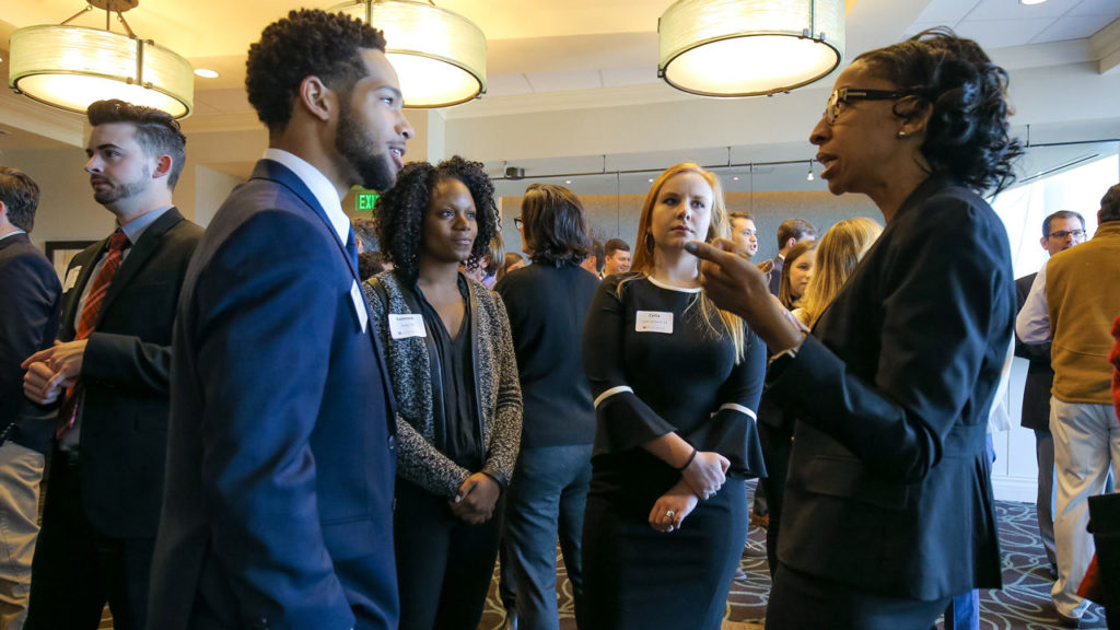Student speaking to career mentor at an event