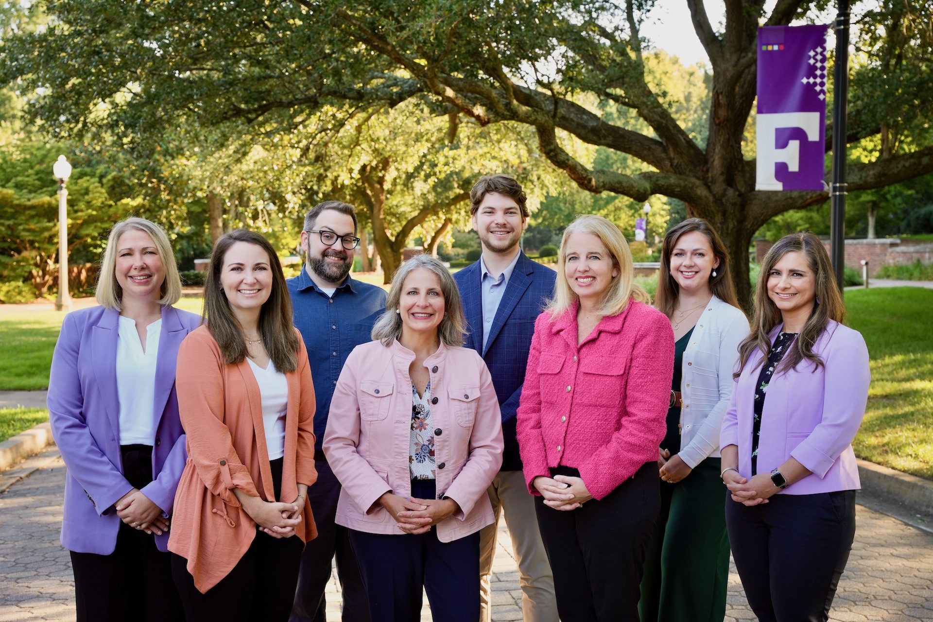 The Malone Center staff at Furman University standing outside in professional dress