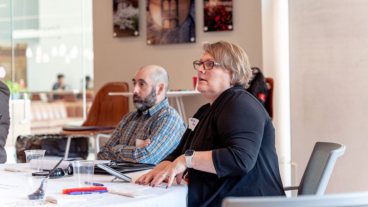 A woman shares her thoughts during a group conversation