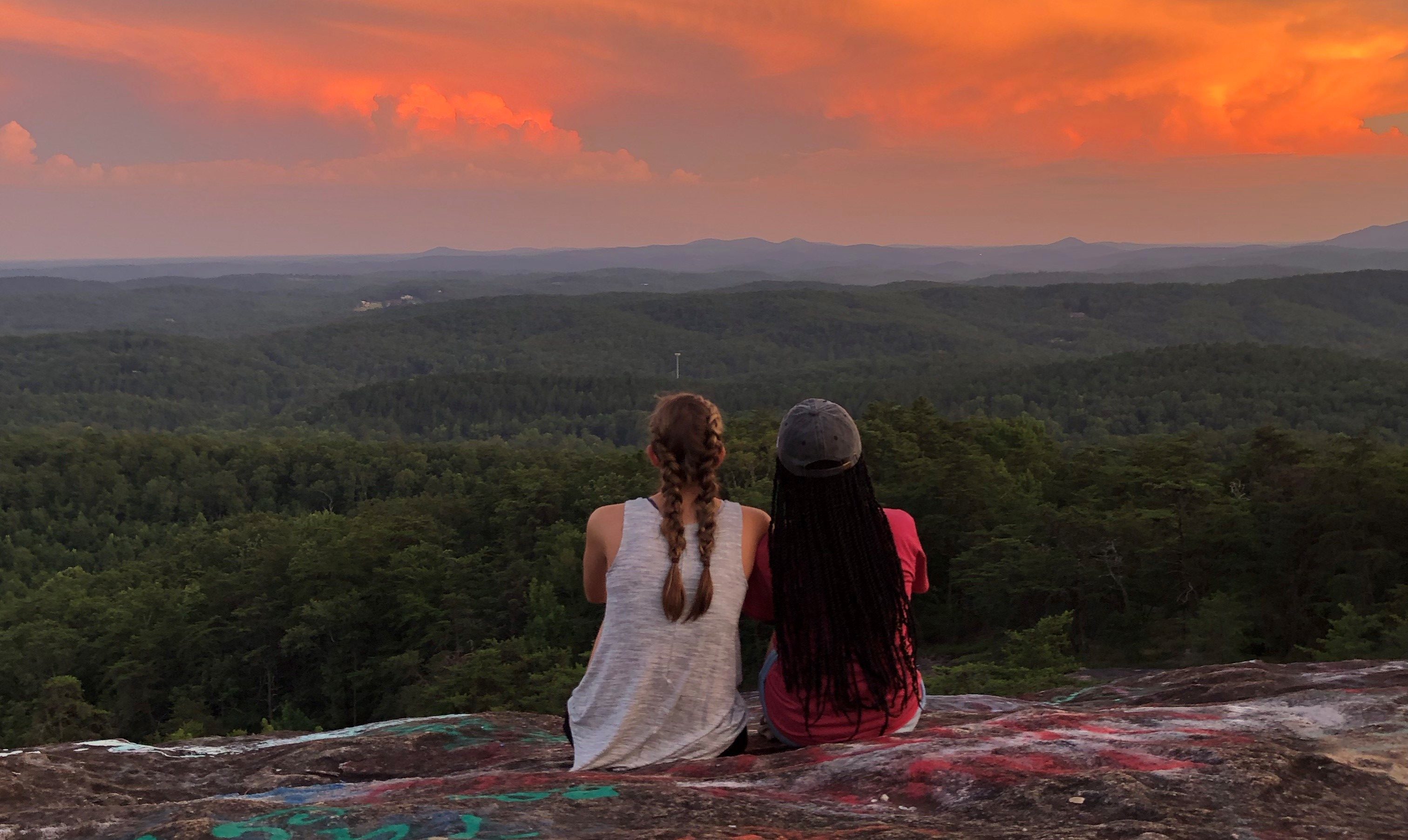 Two students sitting on Bald Rock overlook