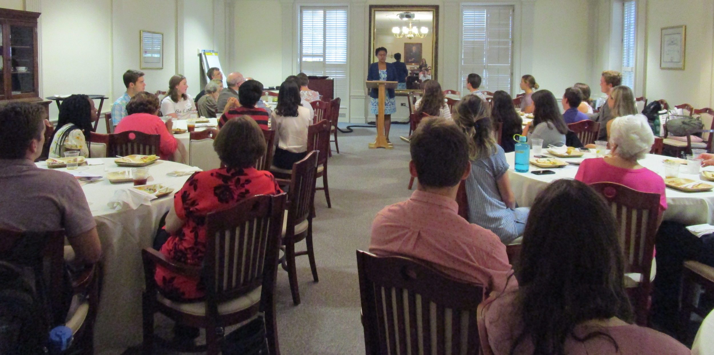 Conversations Dinner event. Speaker is addressing guests.
