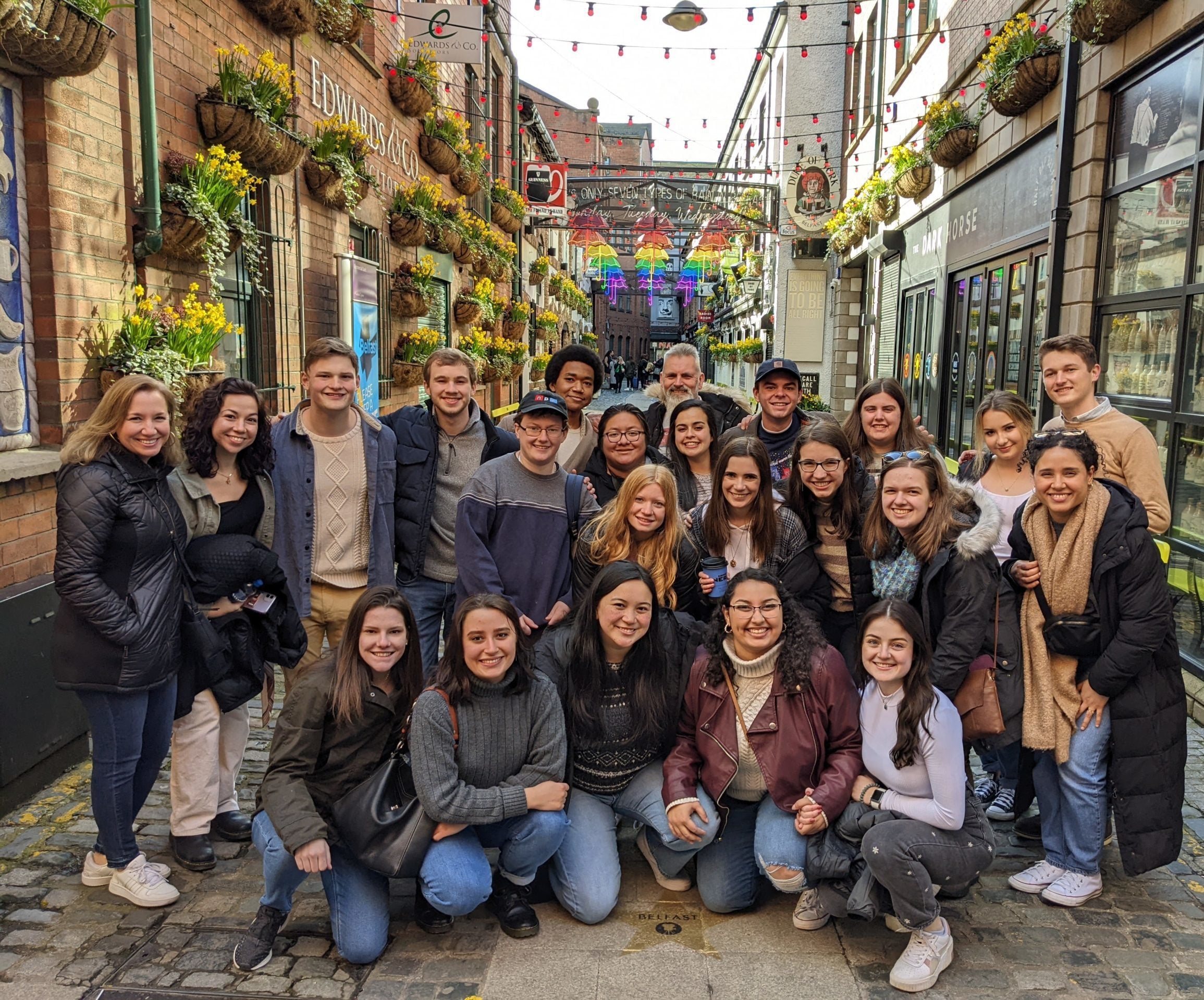 Student participants gathered in a group on a sidestreet in Belfast.