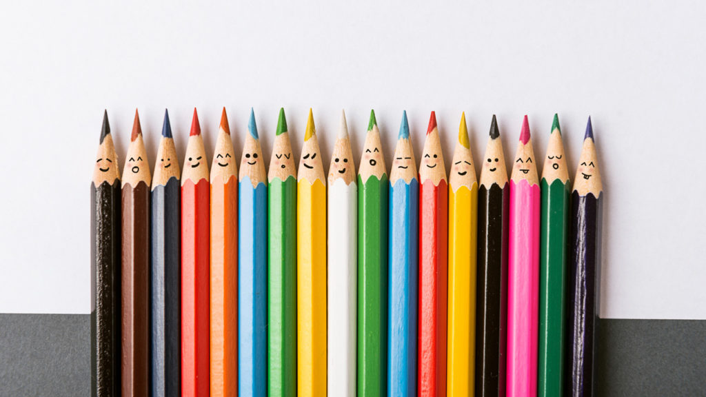 Different colored pencils with faces