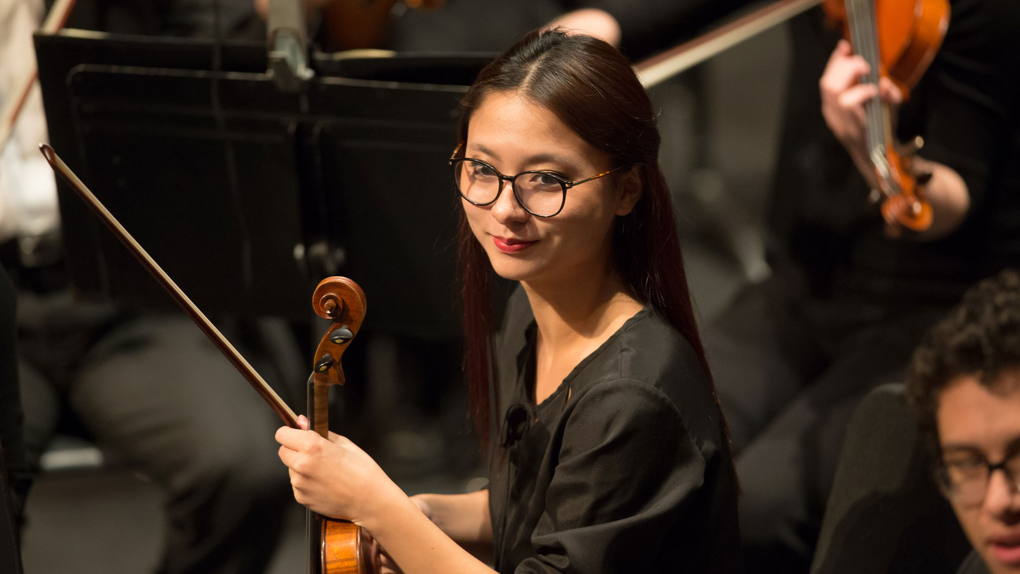 Student holding the violin, preparing to begin playing