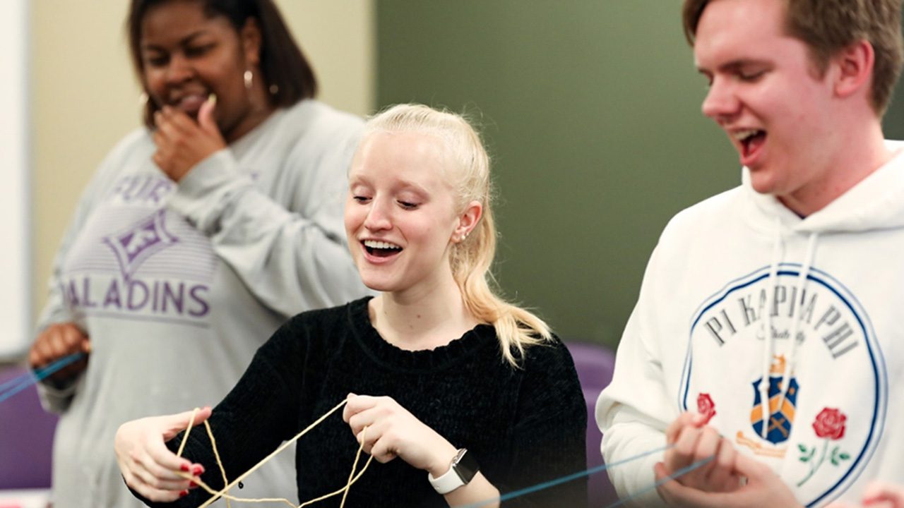 Girl holding strings in the Intergroup Dialogue Program